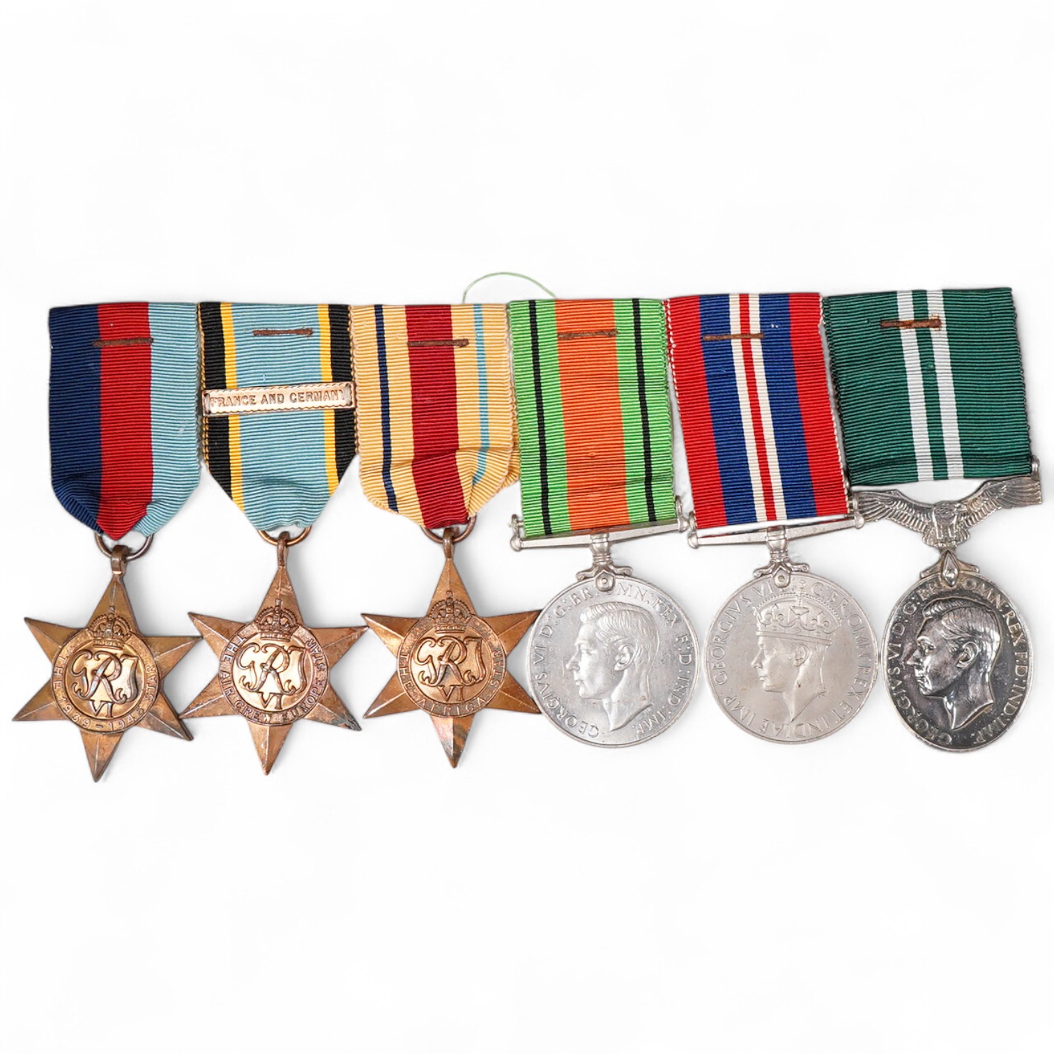 A WWII medal group of six medals, together with the official accompanying paper slip, comprising; the Air Crew Europe star with a clasp for France and Germany, the Africa star, the 1939-1945 star, etc., plus the GVI Air